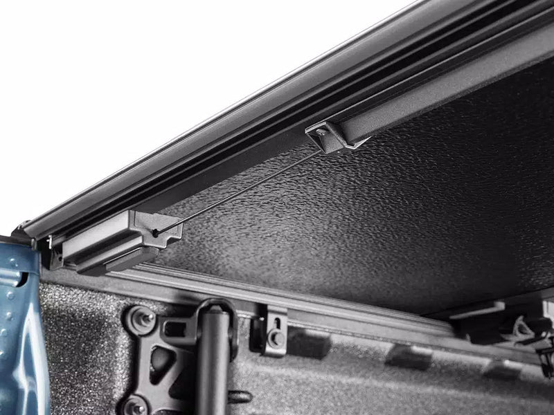 Close-up along the Select cover's side rail showing the drain tube running down to the bed corner.