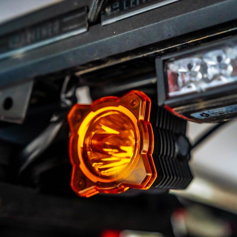 KC HiLiTES FLEX ERA 1 Light Cover & Shield, FLEX ERA 1 with the amber shield fitted, lit on a vehicle