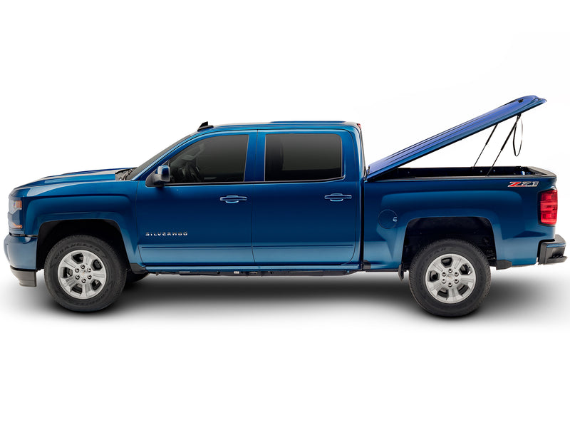 UnderCover LUX one-piece tonneau cover raised on its struts, full side profile, showing how high the lid stands and how far back it clears the box.