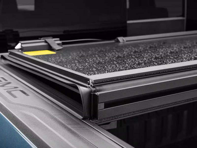 Close-up of the Select folded panel stack, its aluminum frame edge and grit-textured surface.