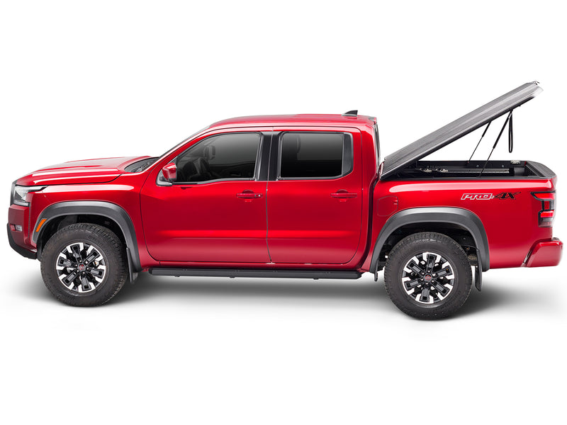 UnderCover Elite one-piece tonneau cover raised on its struts, full side profile, showing how high the lid stands and how far back it clears the bed.