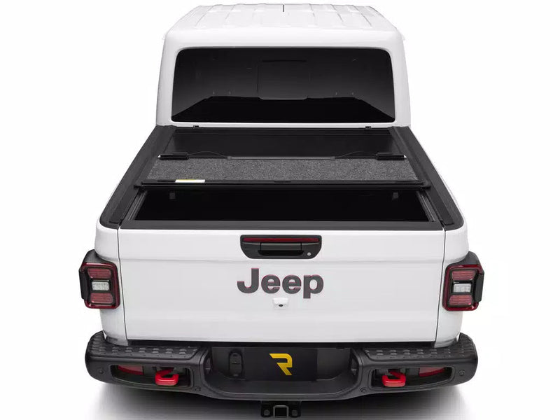 UnderCover Ultra Flex hard folding tonneau cover part-open with the rear panel folded forward, straight rear view.