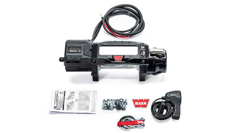 Warn ZEON XC 12 bare drum winch with an empty drum and no fairlead, shown with the corded remote, mounting hardware and manuals