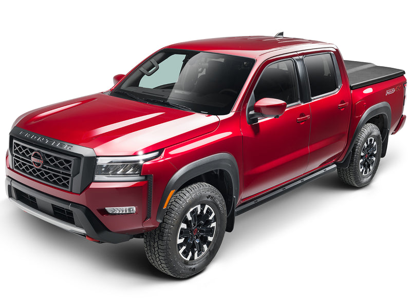 UnderCover Elite one-piece tonneau cover closed on a pickup bed, front three-quarter view with the whole truck in frame and the lid reading as a flat black deck across the box.