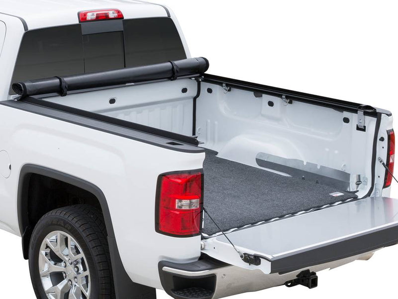 Same studio view with the cover rolled against the cab, tailgate down and the bed fully open
