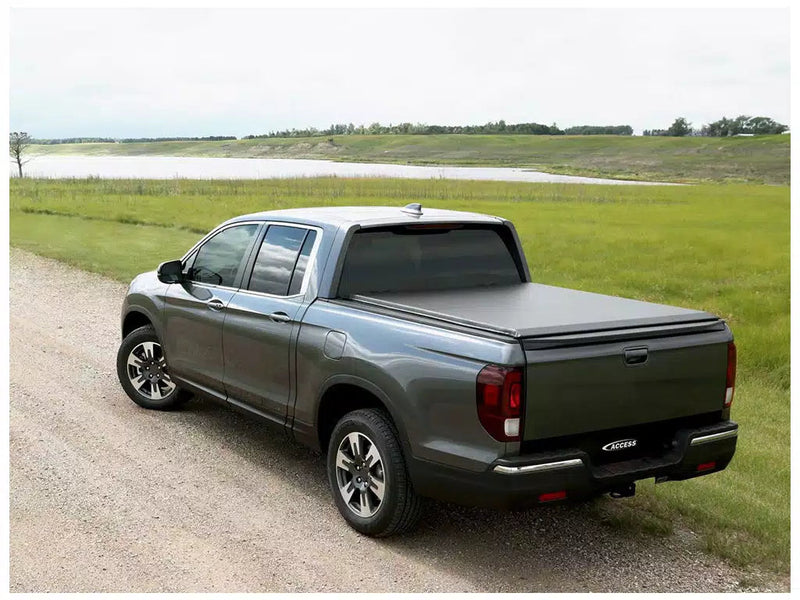 Black soft roll-up cover closed over the bed, rear three-quarter view