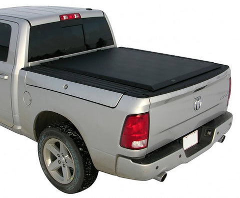 Rear three-quarter close view of a silver crew cab pickup with the black roll-up cover closed flush, white background
