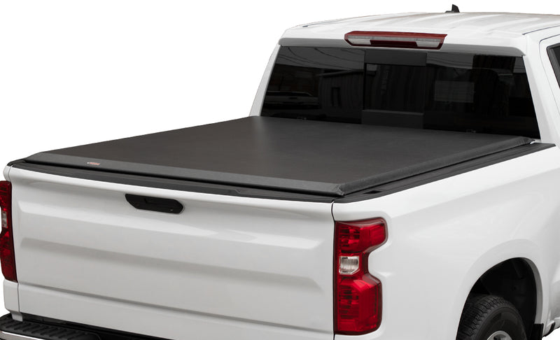 Full view of the Access Original roll-up tonneau cover: white pickup on a white background with a black vinyl roll-up cover closed flat over the bed