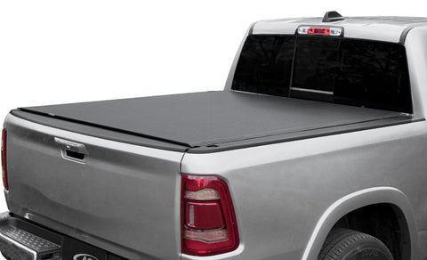 Access Vanish roll-up tonneau cover on a pickup bed: silver pickup on white background, black low-profile roll-up cover closed flat over the bed