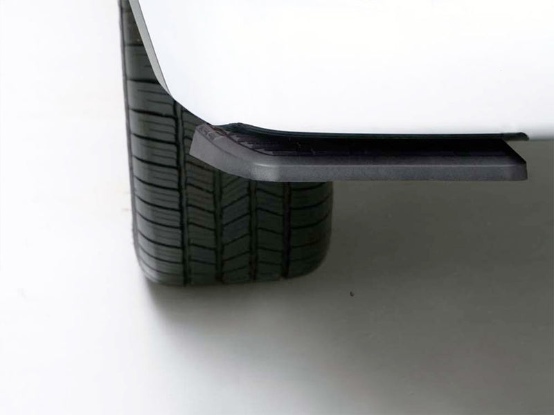 BedStep folded flat under a white rear bumper beside the tire