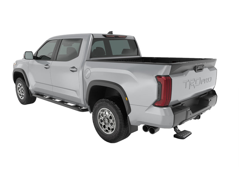 Silver crew-cab pickup in the studio with the BedStep deployed under the rear bumper