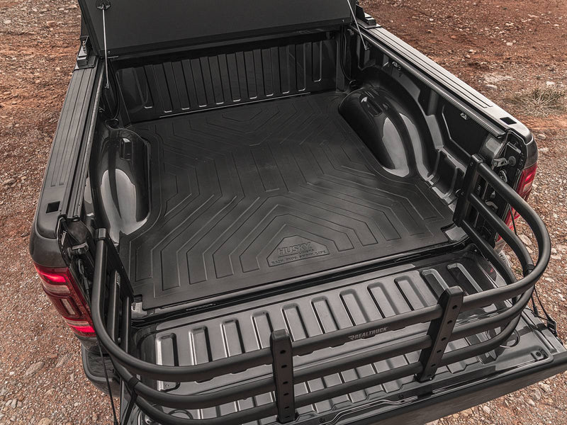 Close overhead view of the BedXTender HD Max extended over the lowered tailgate of a dark pickup outdoors