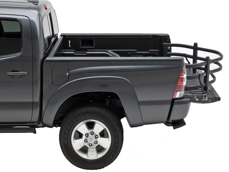 Gray crew-cab pickup in the studio with a black BedXTender HD Moto extended over the lowered tailgate