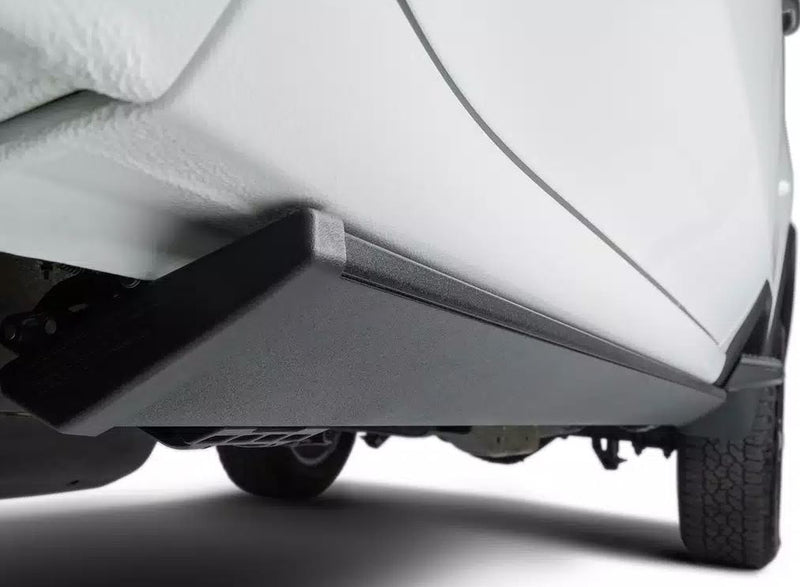 PowerStep stowed tight under the rocker of a white vehicle, studio