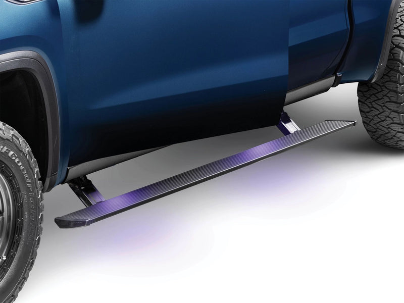AMP Research PowerStep running board deployed below the cab doors with its step lights on