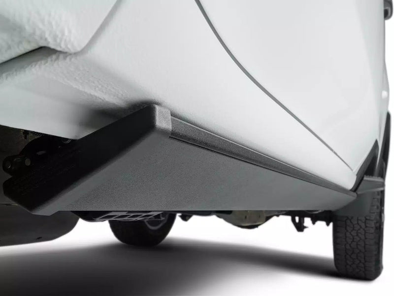 PowerStep stowed tight under the rocker panel of a white pickup