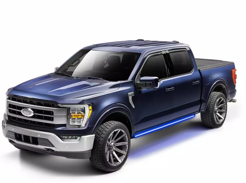 Blue crew-cab pickup in the studio with the running board edge lighting glowing blue