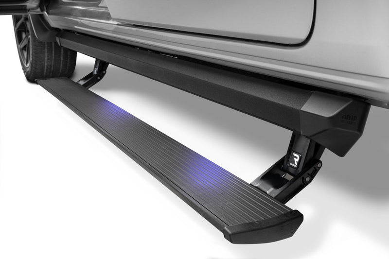 Lit PowerStep XL deployed below the doors of a silver pickup, studio