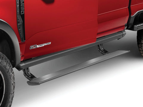 PowerStep XL deployed below the doors of a red heavy-duty pickup, studio