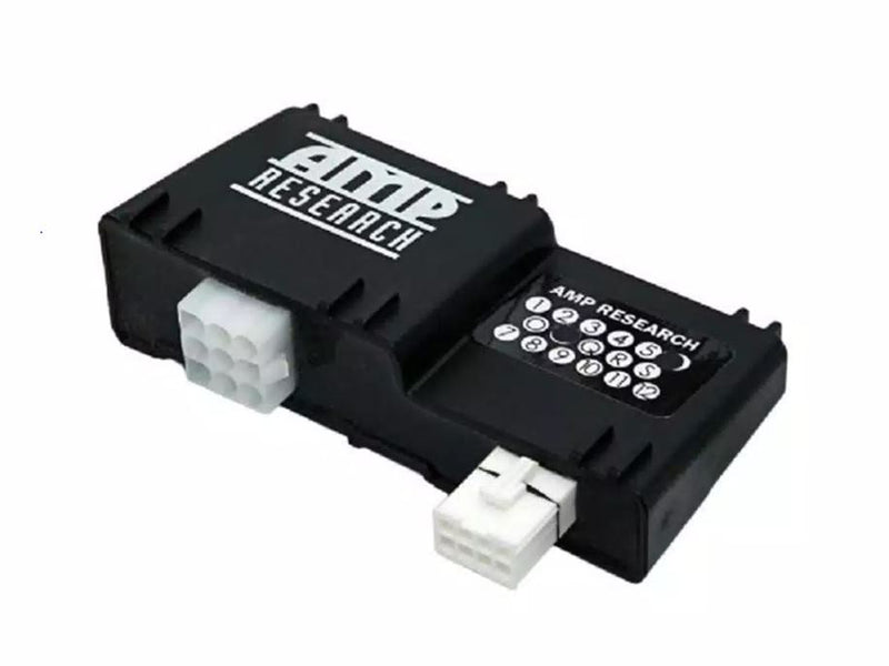 Black AMP Research PowerStep controller with two white connectors on white