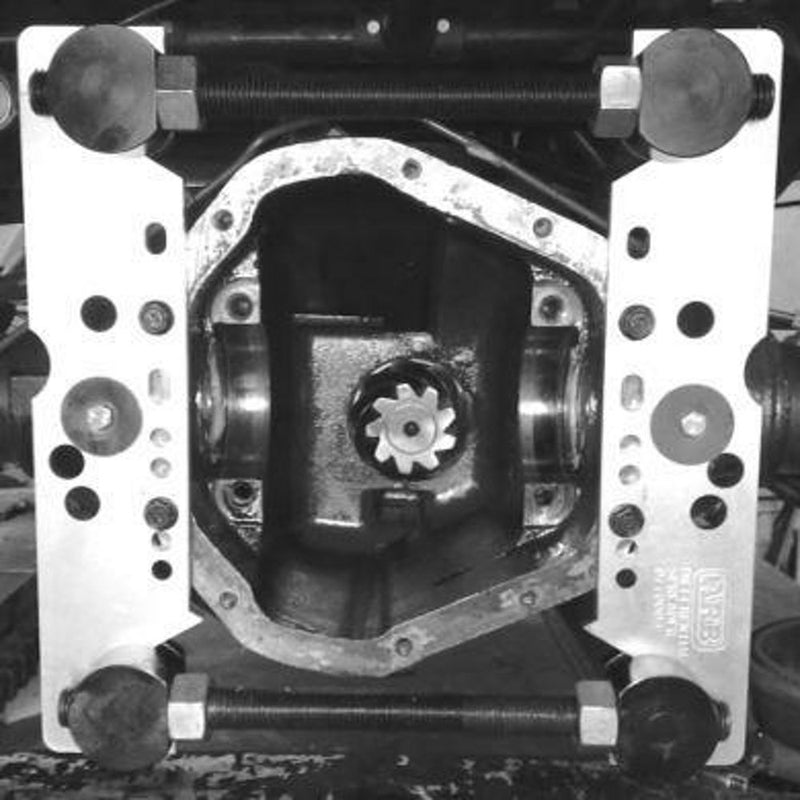 ARB differential case spreader plates and bolts fitted across an open differential housing, black and white photo