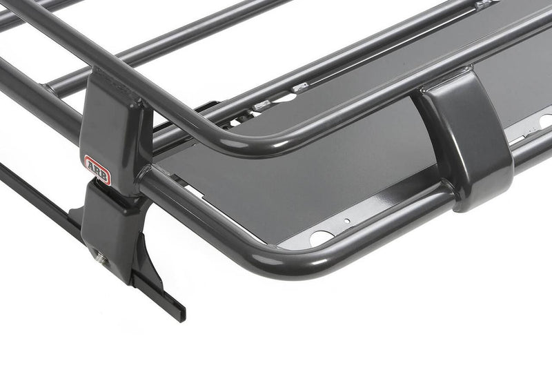 Close-up of an ARB Classic roof rack cage corner with rail clamps, mounting leg and ARB logo plate