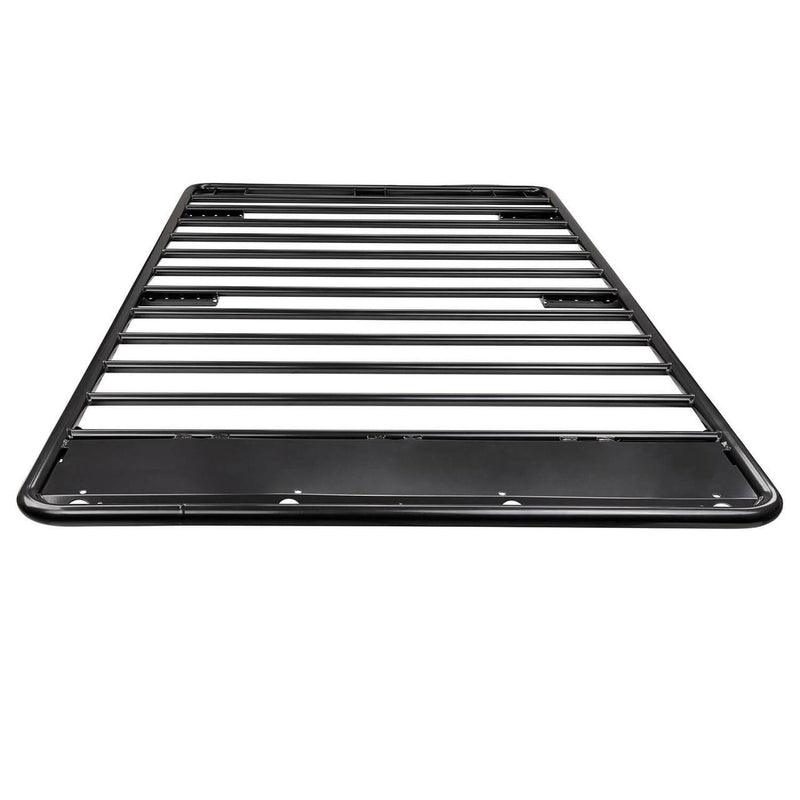 ARB Classic steel flat roof rack on white seen from the front corner, black tube floor with a solid front wind deflector panel