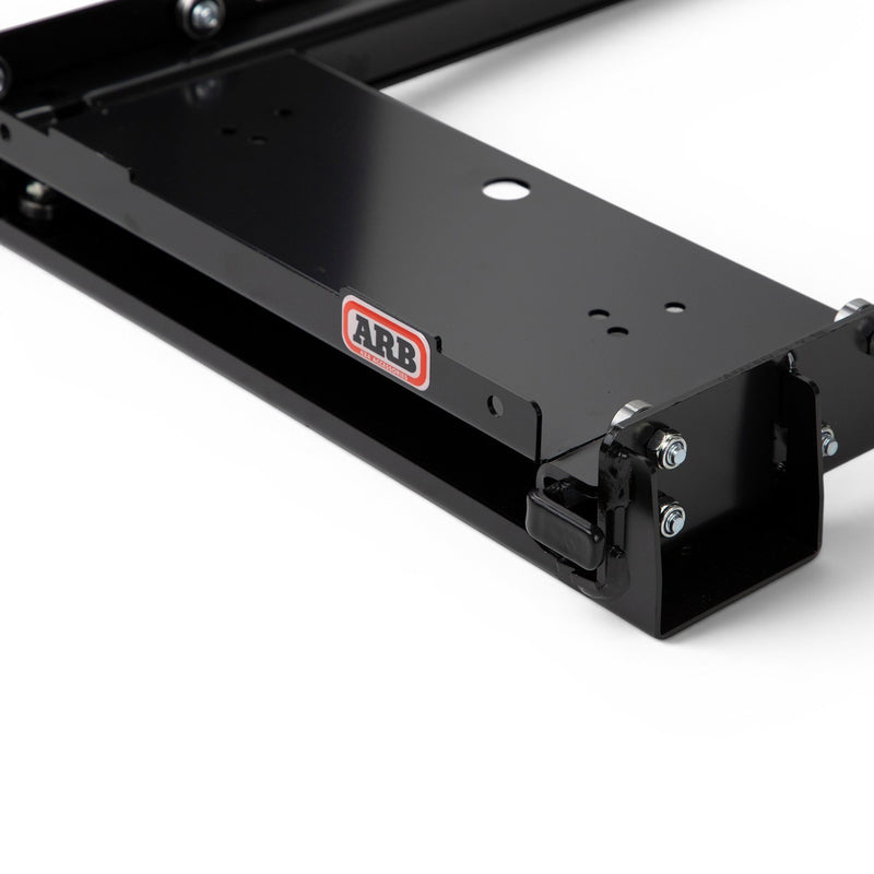 Close-up of the ARB extended platform fridge slide end with ARB badge, latch and mounting holes