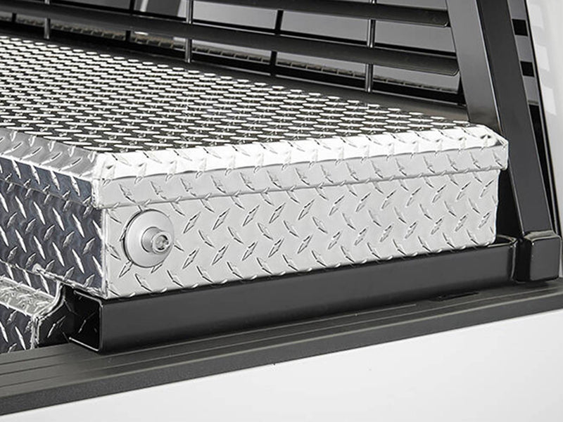 BackRack Crossover Toolbox: black rack raised on toolbox brackets behind a polished diamond plate crossover toolbox on a white truck