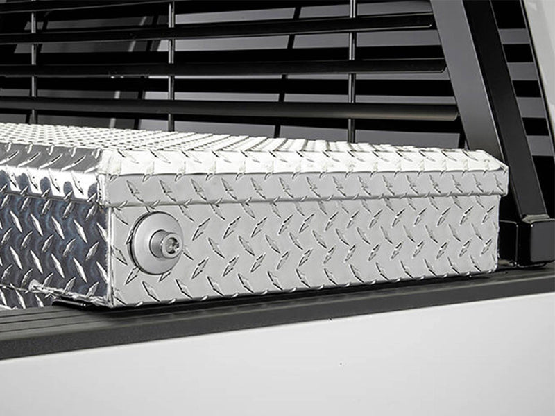 BackRack Low Profile: black rack mounted on low profile brackets just behind a diamond plate crossover toolbox on a white truck