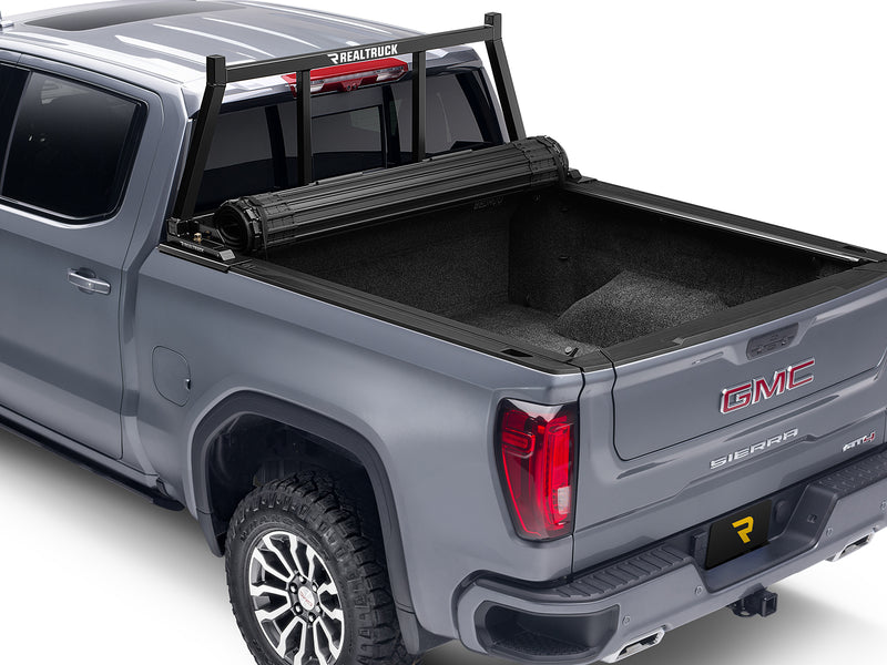 BackRack Open: A black open headache rack is mounted on a gray GMC Sierra with a rolled tonneau cover