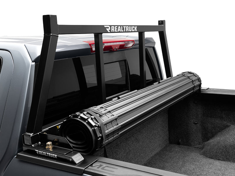 BackRack Open: A black open headache rack stands behind a rolled tonneau cover on a gray GM pickup