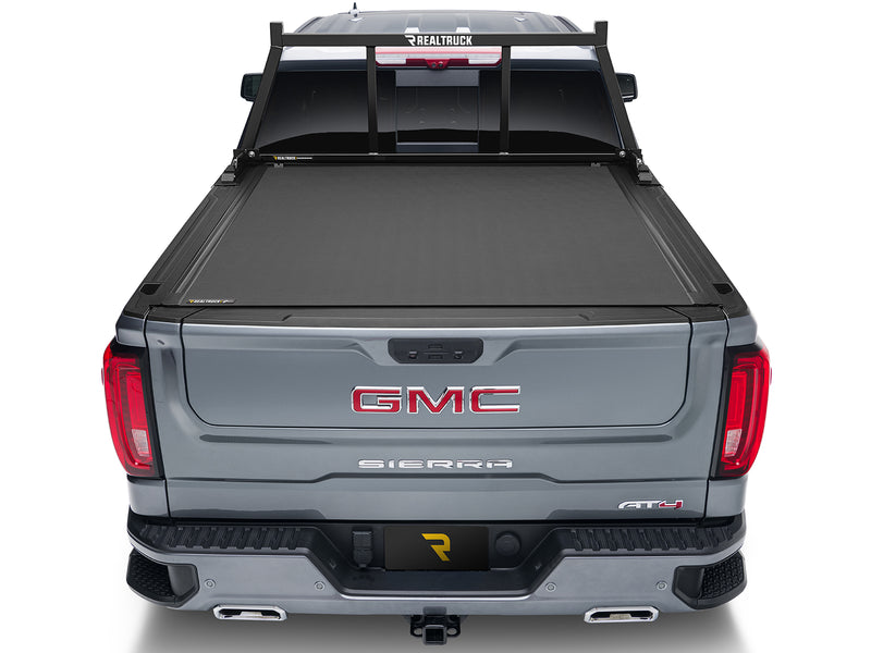 BackRack Open: rear view of a gray GMC Sierra with a black open headache rack and a closed tonneau cover