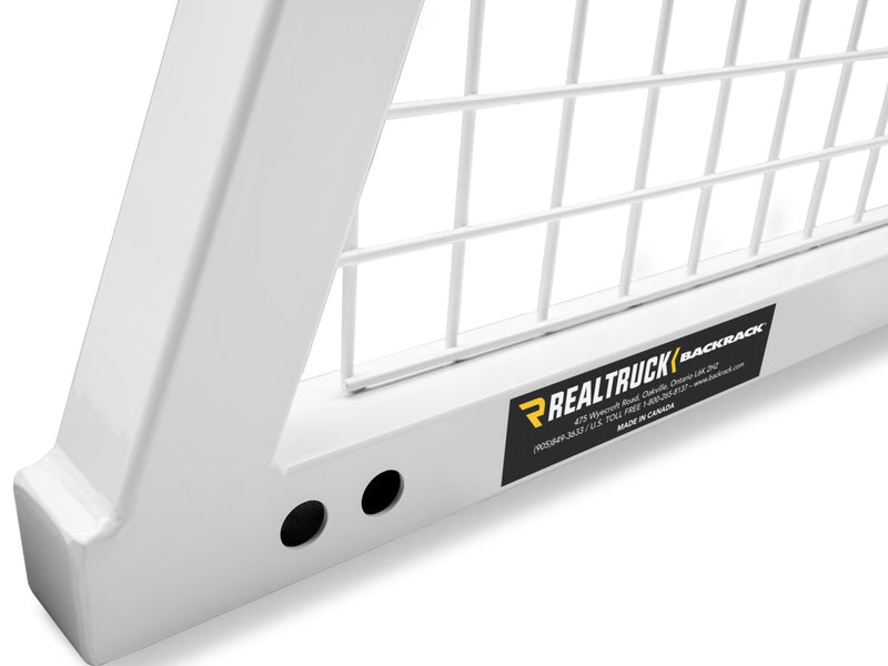 BackRack Safety: close-up of a white Safety headache rack base corner with mesh screen and the RealTruck BackRack label