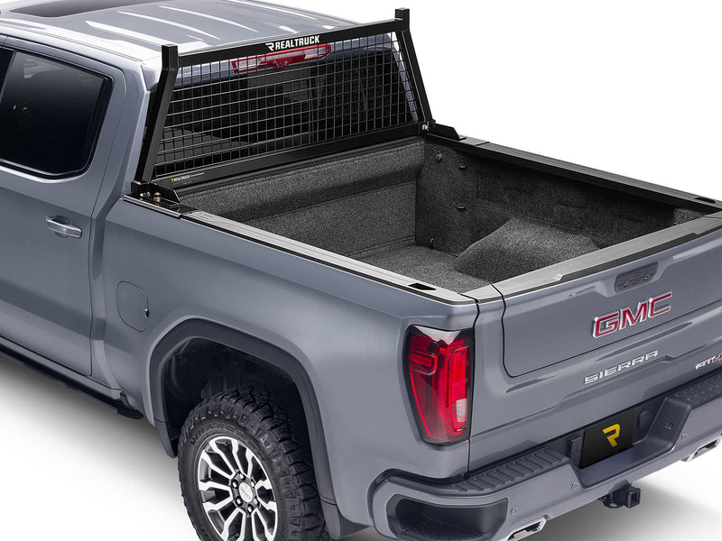 BackRack Safety: gray pickup with a black Safety headache rack mounted behind the cab and an empty carpeted bed