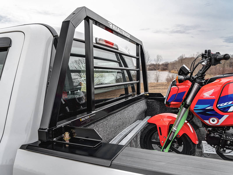 BackRack SR: A black SR headache rack behind the cab of a white pickup with a red minibike strapped in the bed