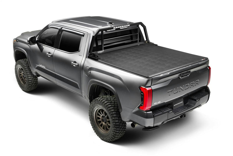 BackRack SR: rear three-quarter view of a gray pickup with a black SR headache rack behind a soft roll-up tonneau cover