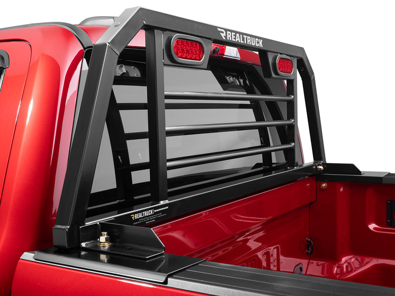 BackRack SRL: close view of a black headache rack with horizontal bars and red oval lights bolted to the bed rails of a red pickup
