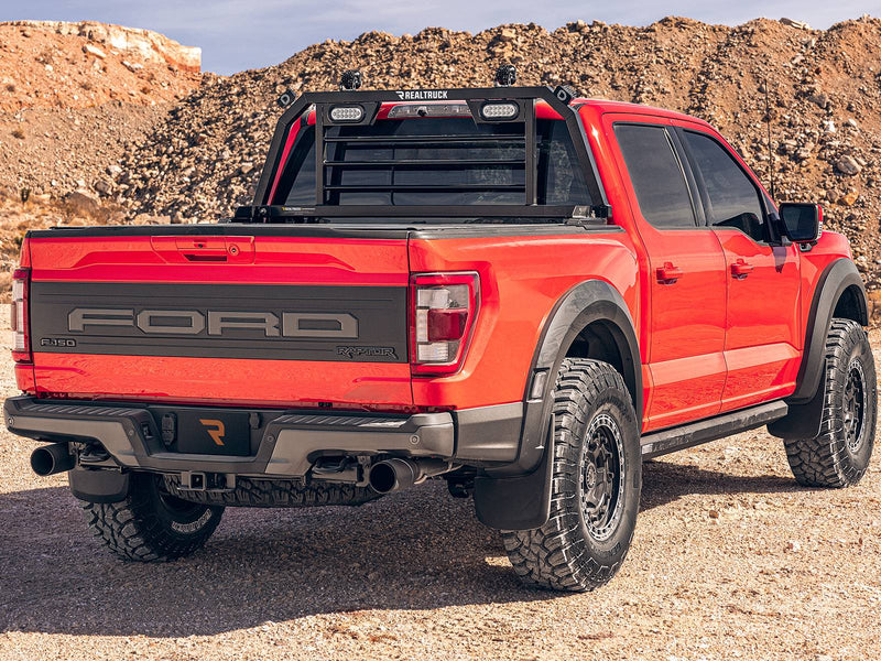 BackRack SRL: rear three-quarter view of a red Ford F-150 Raptor with a black SRL headache rack fitted with white oval lights