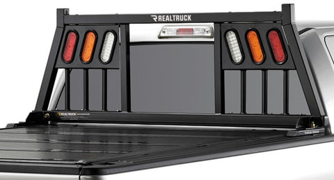 BackRack Three Light: black Three Light headache rack with three light openings mounted behind the cab of a pickup, seen from the rear quarter