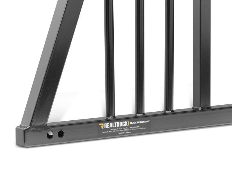 BackRack Three Round: close-up of a black headache rack lower corner with vertical bars and a RealTruck BackRack product plate (149TR size shown; your part is the same Three Round design sized for your truck)