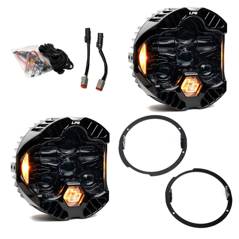 Baja Designs DOT LP6 LED Headlight Kit, complete kit on a studio background: A pair of LP6 LED headlights with amber accent glow, two mounting rings, adapter leads and a wiring pack on white