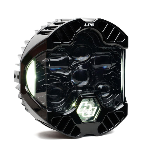 Baja Designs DOT LP6 LED Headlight Replacement, whole product on a studio background: A single LP6 LED headlight with a clear lens and white accent light glowing, on white