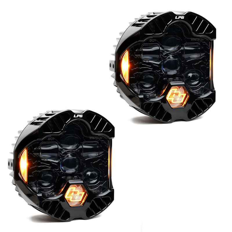 Baja Designs DOT LP6 LED Headlight Replacement Pair, whole product on a studio background: A pair of LP6 LED headlights with clear lenses and amber accent lights glowing, on white