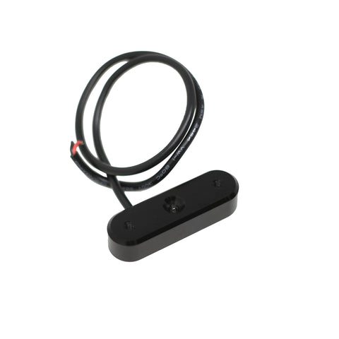 Baja Designs Follow Me Infrared LED Light Pod, whole product on a studio background: A low-profile black oval Follow Me infrared light pod with its coiled wiring lead on a white background