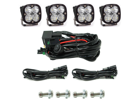 Baja Designs Squadron Sport Grille Light Kit, complete kit on a studio background: four Squadron Sport pods with clear lenses, a switch harness, two extension harnesses and four mounting bolts on white