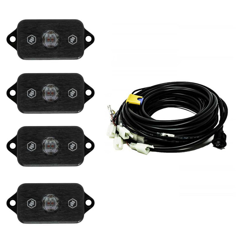 Baja Designs LED Rock Light Kit, complete kit on a studio background: four black LED rock light pods with red centers shown with a coiled multi-lead wiring harness on white