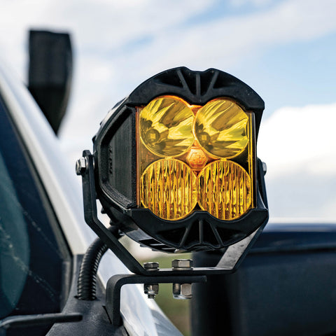 Baja Designs LP4 IPT Reflector Covers, representative image: IPT reflector cover shown fitted inside an LP4 light; the light itself is not included. An LP4 light with amber reflector covers on a pillar mount beside a truck windshield, vehicle not