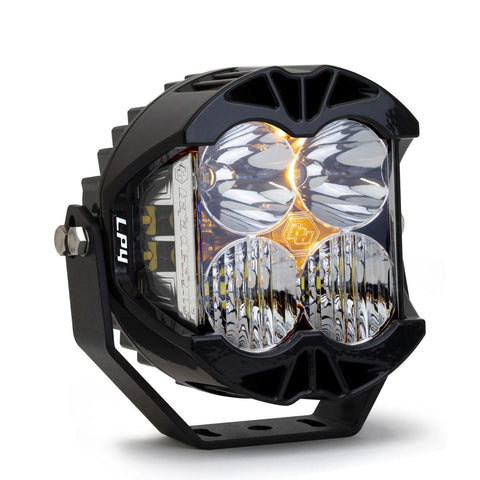 Baja Designs LP4 Pro LED Auxiliary Light Pod, whole product on a studio background: A black LP4 Pro LED pod with clear lenses and a small amber backlight glow, angled on a white background