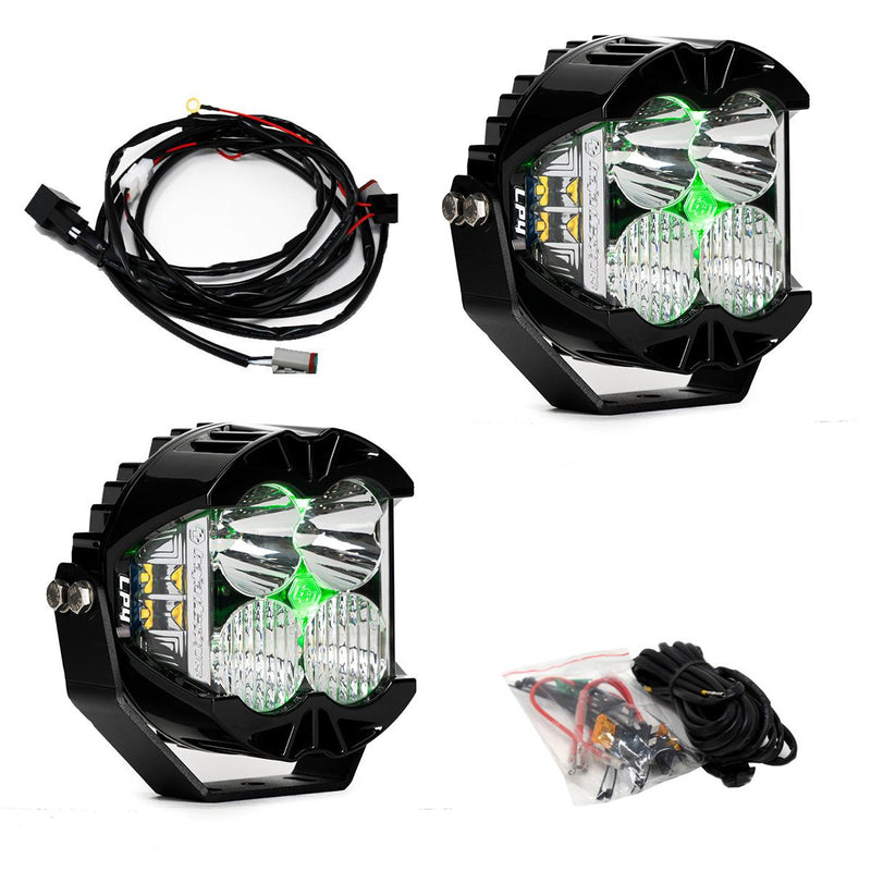 Baja Designs LP4 Pro LED Auxiliary Light Pod Pair, whole product on a studio background: A pair of LP4 Pro LED pods with clear spot lenses and green backlights glowing, with a wiring harness and hardware bag on white
